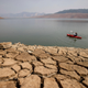 A kayaker fishes in Lake Oroville as water levels remain low due to continuing drought conditions in Oroville, California.